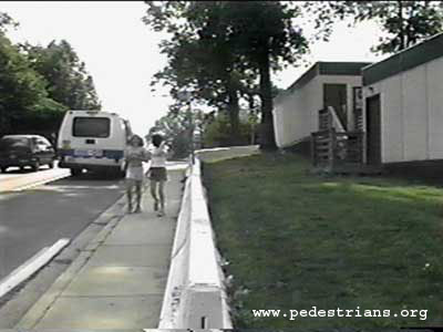 Photo - concrete barriers by sidewalk