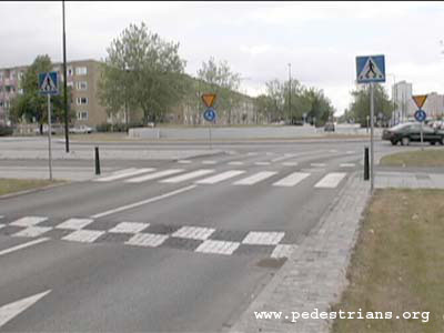 Roundabout in Sweden with speed humps.