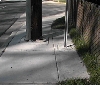 A signpost is placed in the middle of the widened sidewalk.